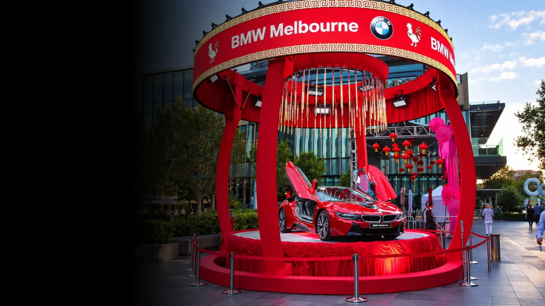 Product and brand activation featuring a red BMW i8 with raised doors on a circular display stage.