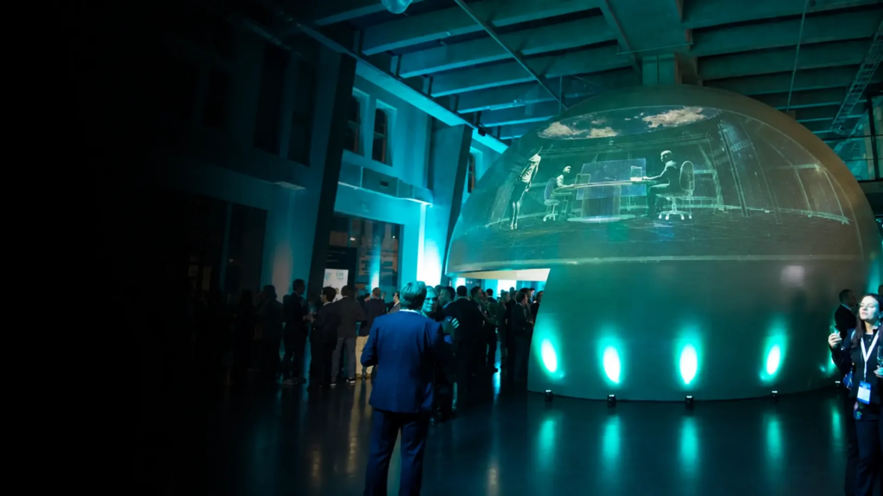 Projector hire for an event featuring large-scale dome projection and turquoise lighting.